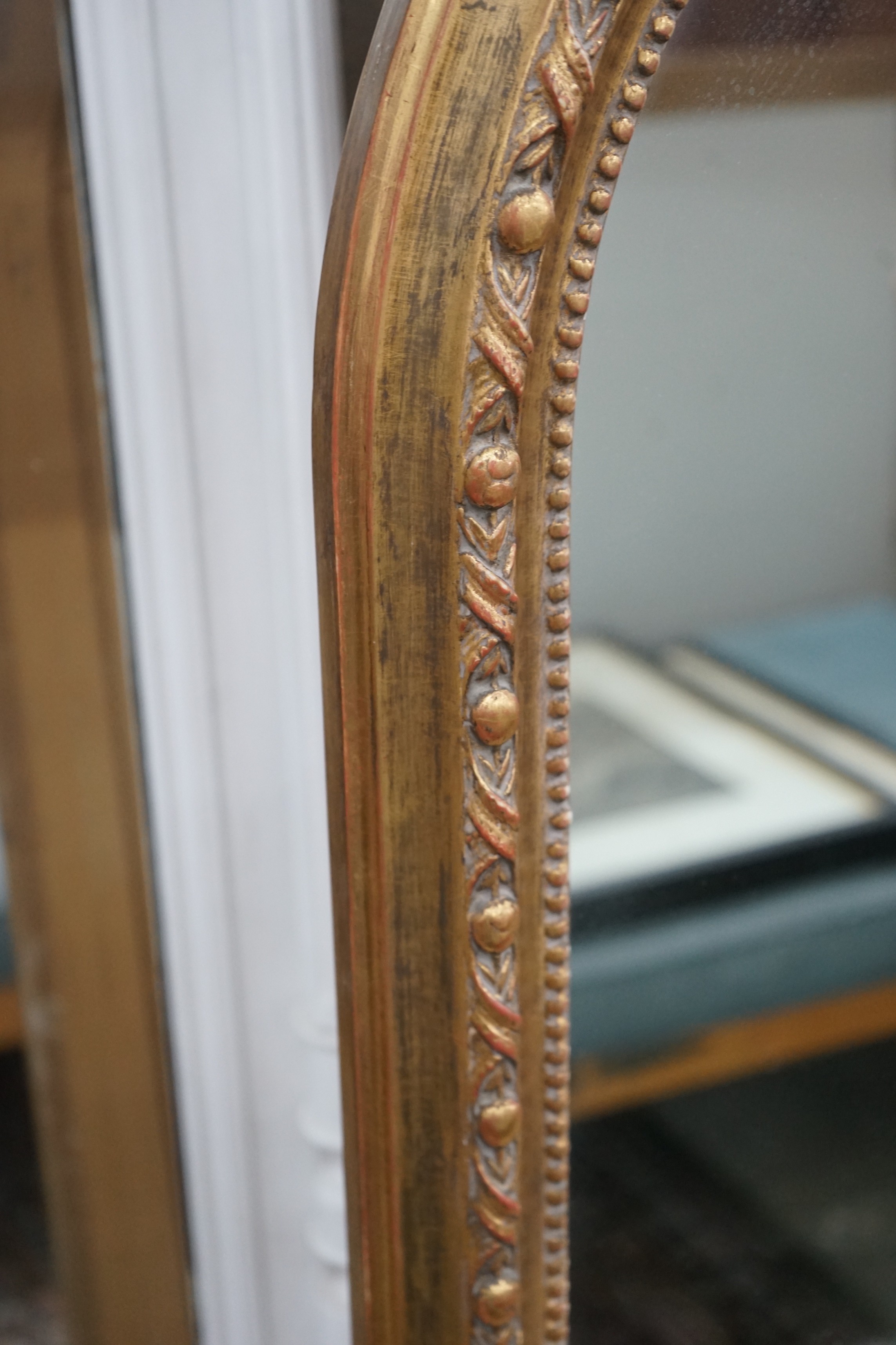 A Victorian style giltwood and composition overmantel mirror, width 136cms, height 138cms.